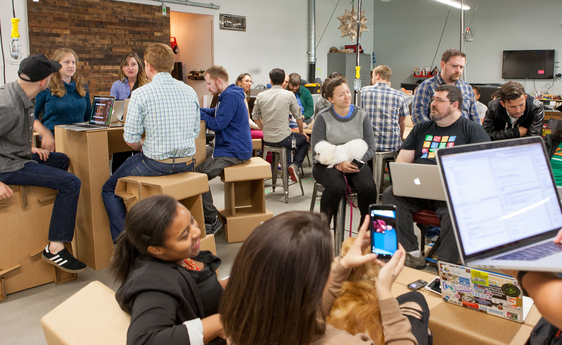 Diverse groups of people working in a shared garage-like space