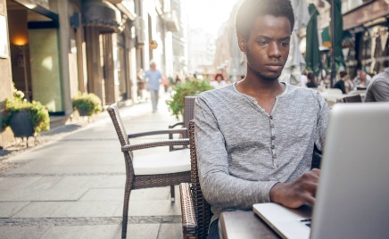 Man sitting outside with a laptop